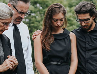 family mourning at cemetery