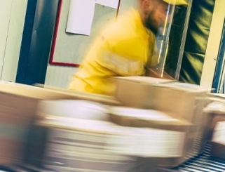 workers inspecting packages on a conveyor belt